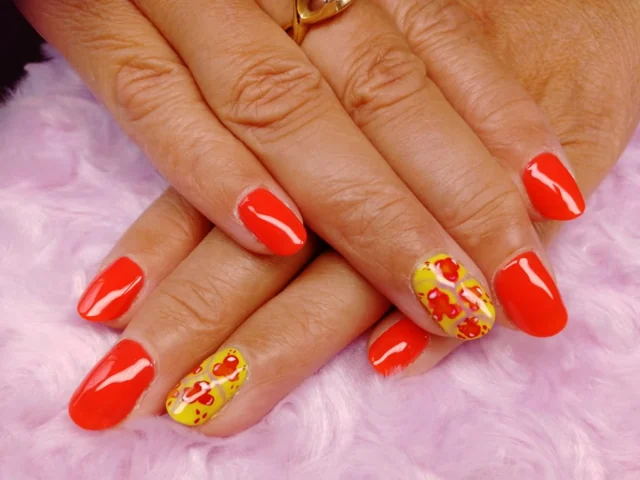 Red gel nails with colourful floral accent nails by Tammy